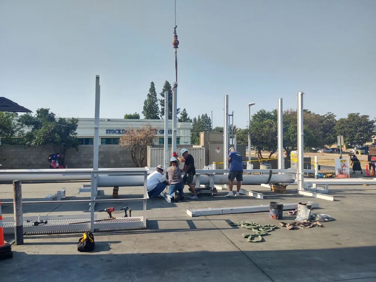 Crew assembling a billboard frame on site